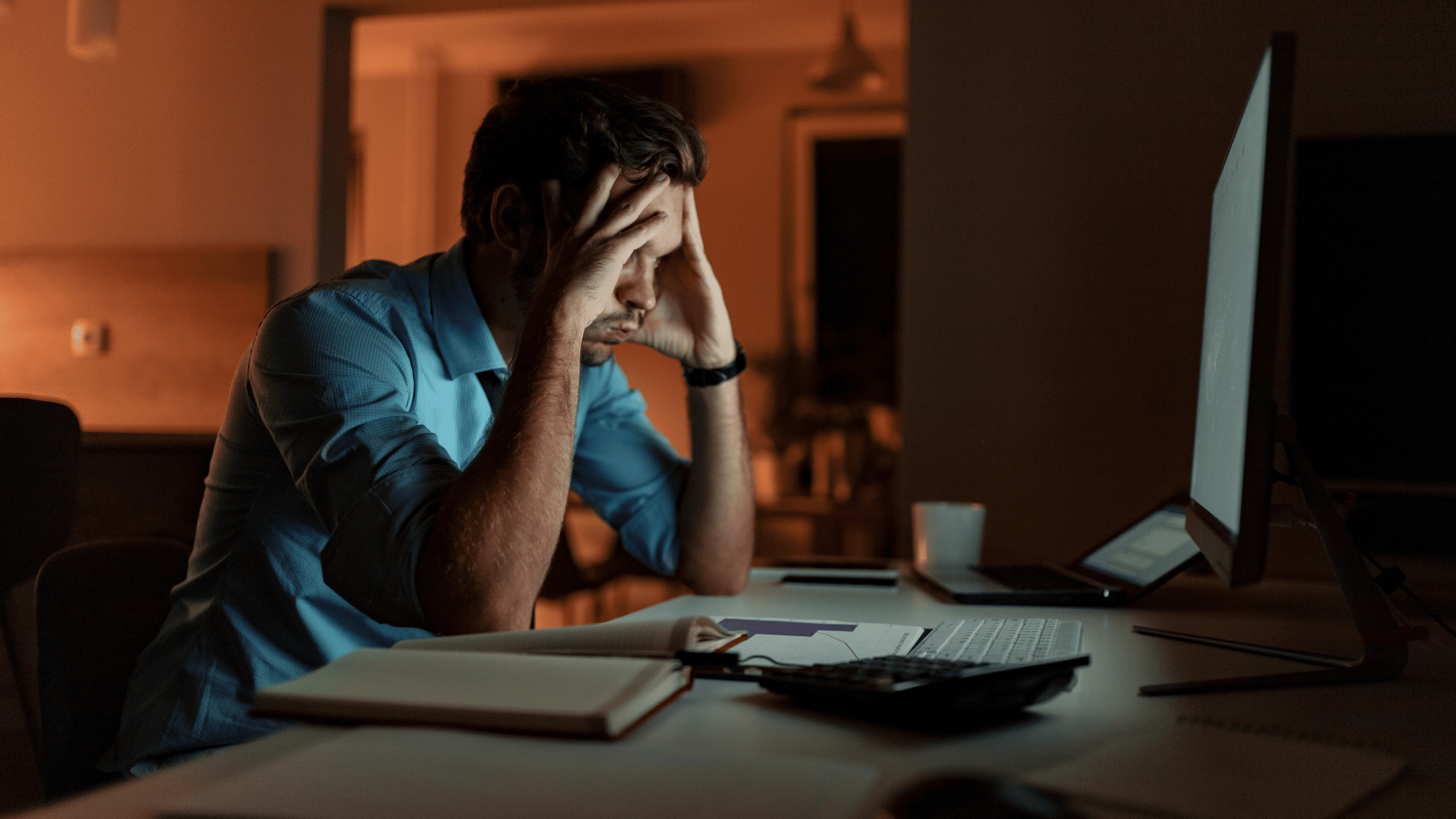 burned out working business man with hands on face