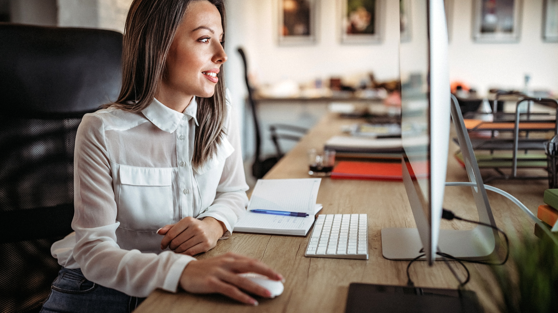 Woman working in front of the computer wearing white blouse and hand on mouse. Outsourcing and staffing Filipino professionals. Hire skilled workers from the Philippines. Hire with WorkfromPH.com