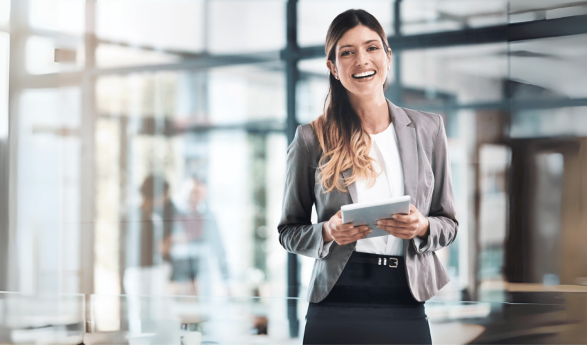 Portrait of a young woman holding a tablet at a modern office space